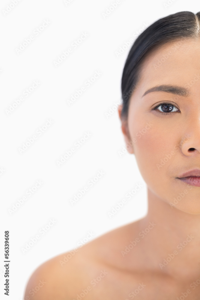 Half face of serious natural woman Half face of serious natural woman