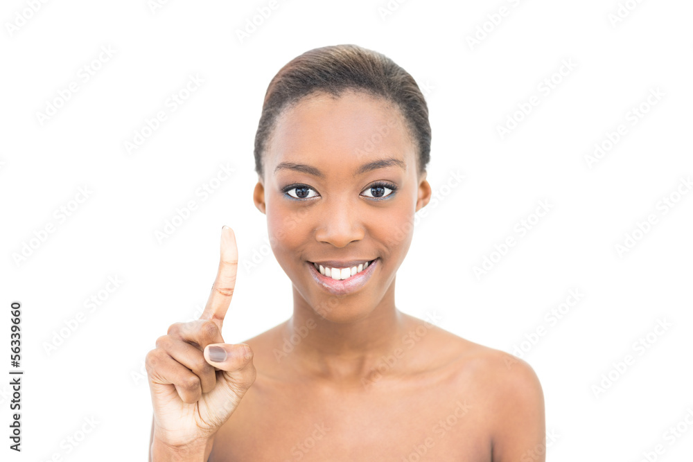 Smiling natural beauty pointing her finger up Smiling natural beauty pointing her finger up