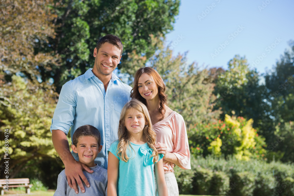 Cheerful family standing in the countryside