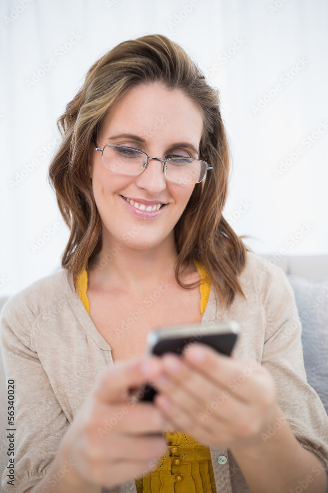 Smiling attractive woman wearing glasses using phone Smiling attractive woman wearing glasses using phone