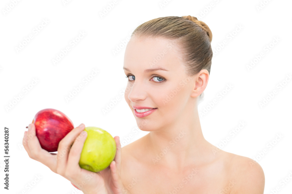Cheerful pretty blonde model holding two apples Cheerful pretty blonde model holding two apples