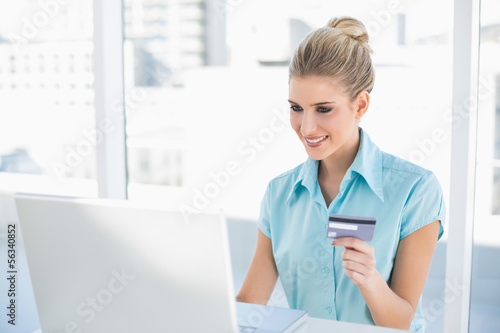 Cheerful smart businesswoman shopping online