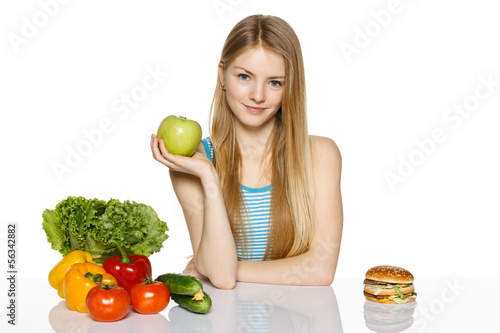 Woman choosing between healthy food and fast food