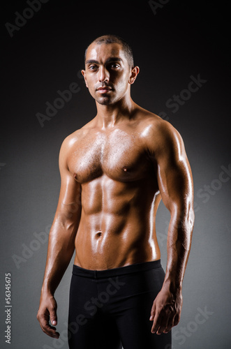 Ripped young man in bodybuilding concept