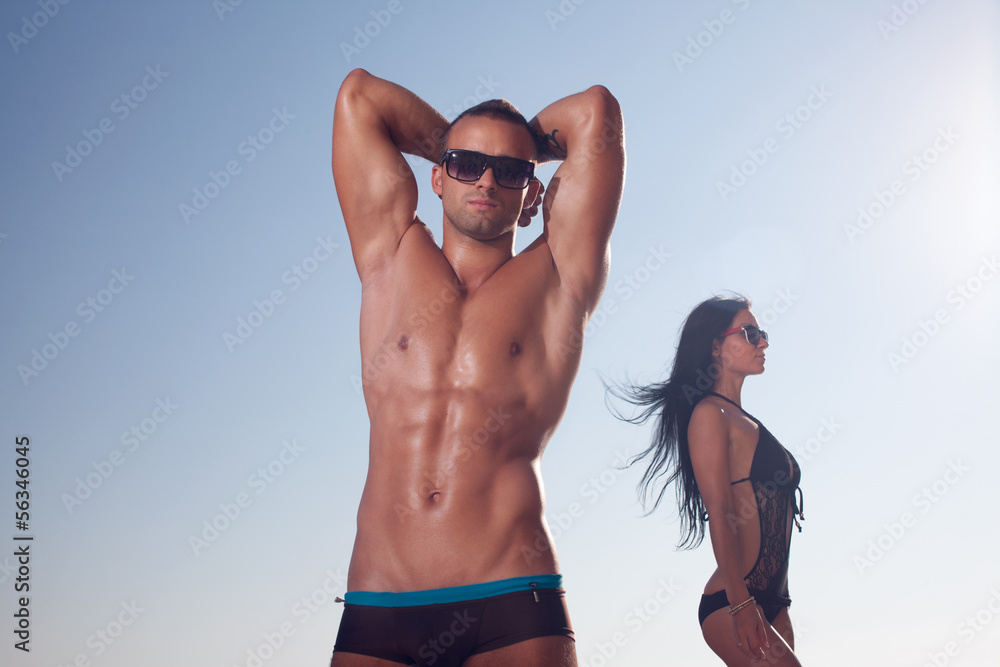 Sporty guy posing on the beach. Sporty guy posing on the beach.
