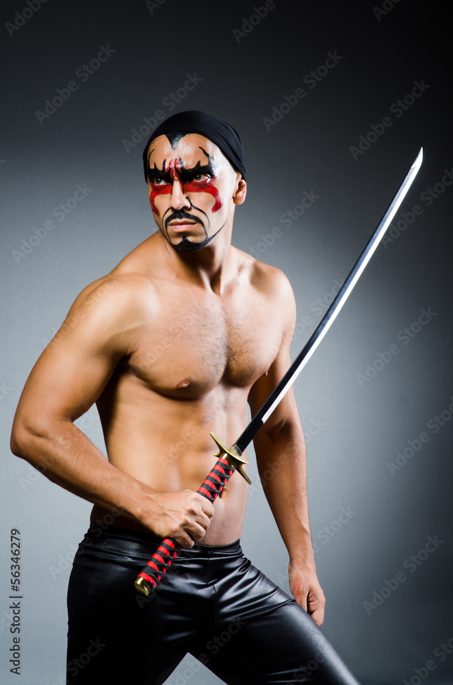 Man with sword and face paint Man with sword and face paint