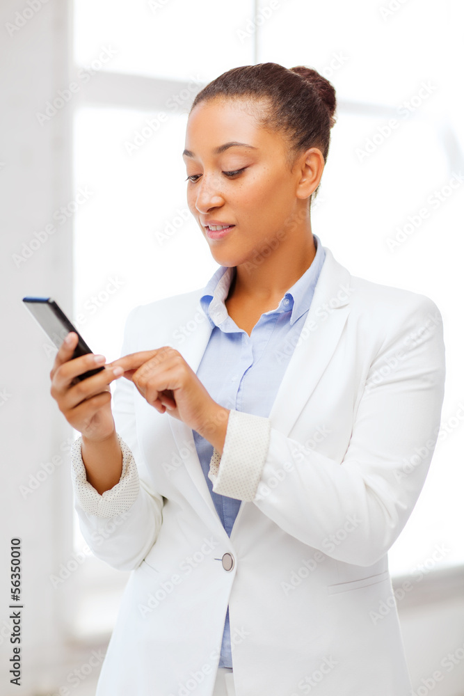 african businesswoman with smartphone in office african businesswoman with smartphone in office