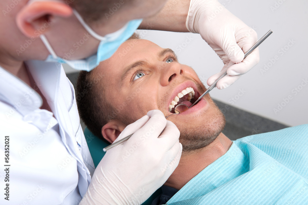 Patient at dentist office. Top view of man sitting at the chair Patient at dentist office. Top view of man sitting at the chair