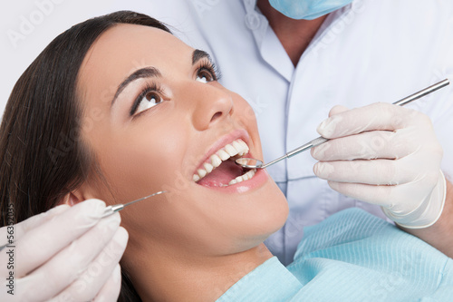 Patient at dentist office. Close-up of young woman sitting at th