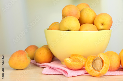 Fresh natural apricot in bowl on table in kitchen