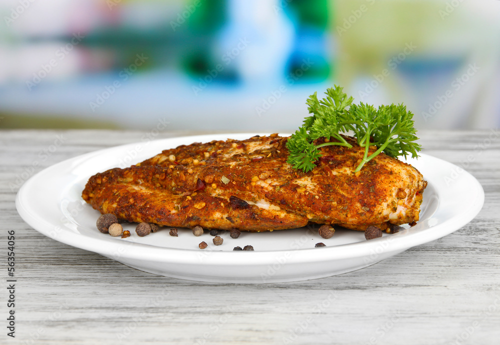 Roasted chicken fillets on white plate on bright background Roasted chicken fillets on white plate on bright background