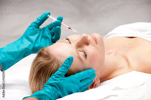 Beauty woman giving facial injections.