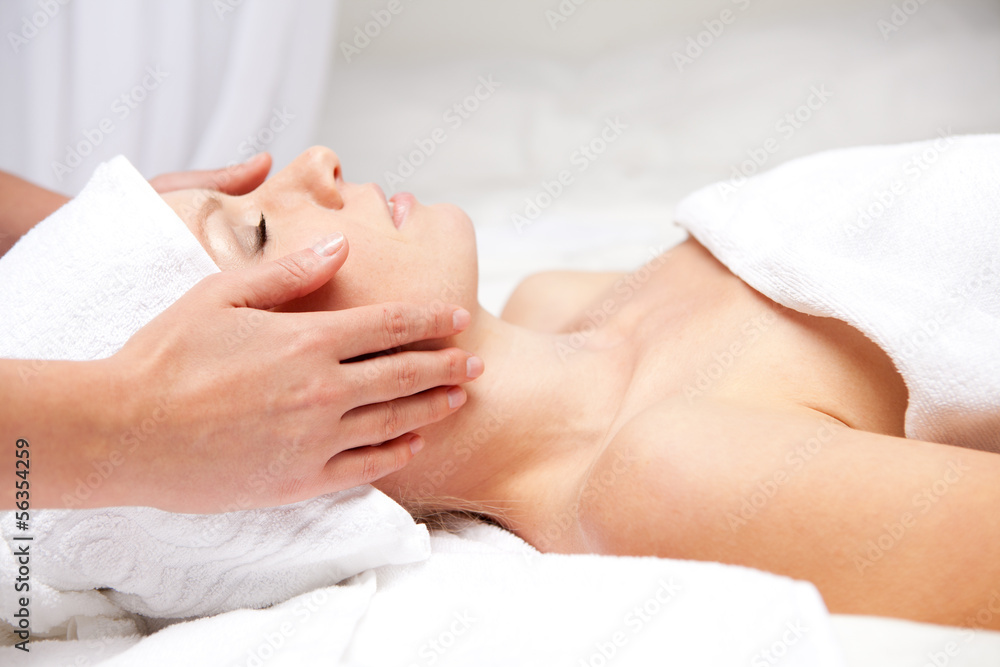 Woman getting massaging treatment over white background Woman getting massaging treatment over white background
