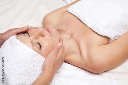 Woman getting massaging treatment over white background