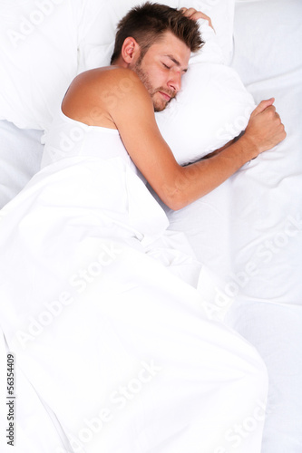 Handsome young man in bed © Africa Studio