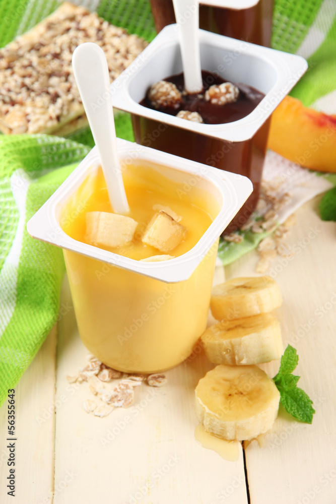 Tasty cream desserts with pieces of fresh fruits, cookies and Tasty cream desserts with pieces of fresh fruits, cookies and