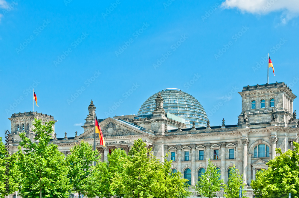 Fototapeta premium German Parliament with national flag in Berlin