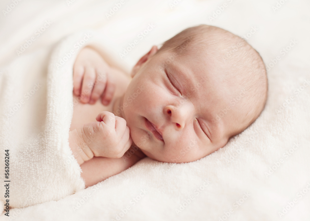 Newborn baby girl asleep on a blanket. Newborn baby girl asleep on a blanket.
