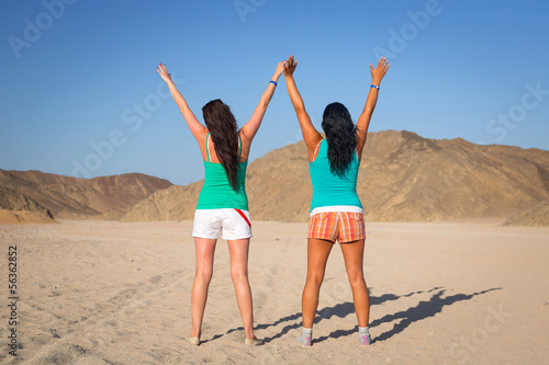 Two happy girls on the desert of Egypt