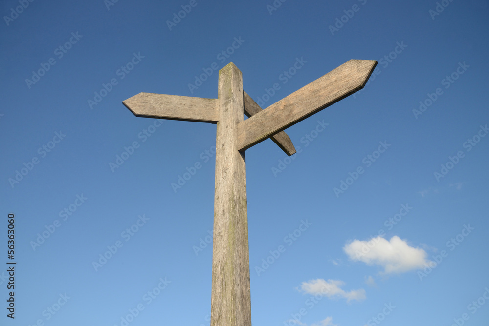 Blank signpost with blue sky and clouds