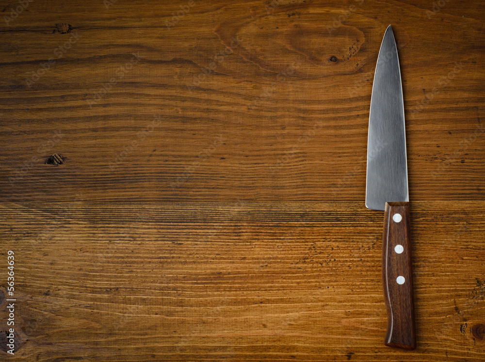 Knife on rustic kitchen table with copy space