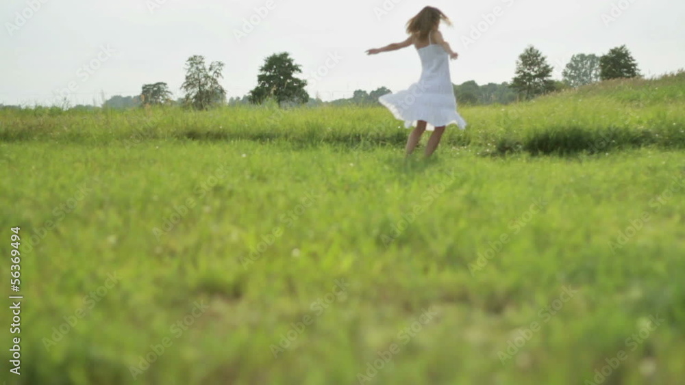 Carefree young woman on the grass, slow motion Carefree young woman on the grass, slow motion