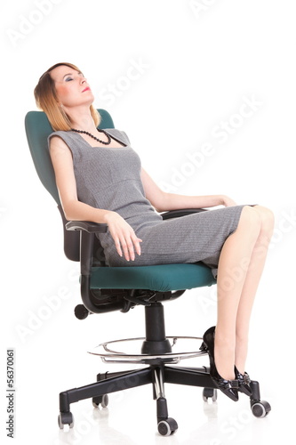 Full length business woman sitting on chair holding clipboard is