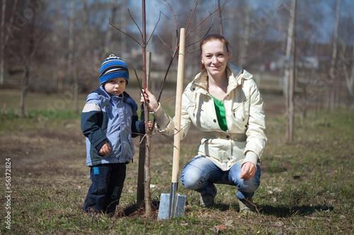 mother and son planting tree