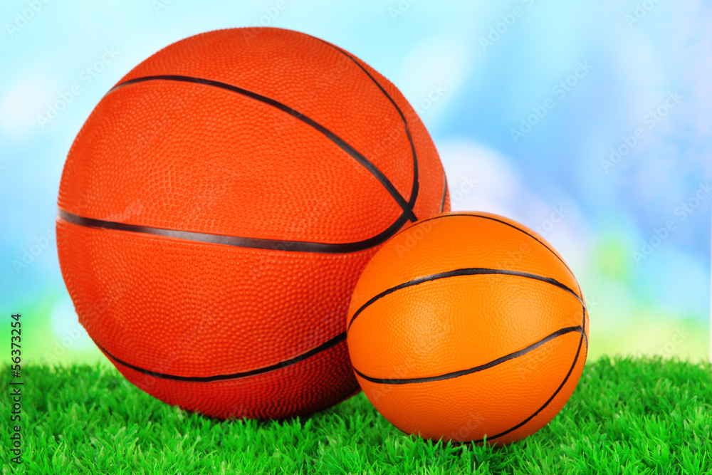 Basket balls, on green grass, on bright background Basket balls, on green grass, on bright background