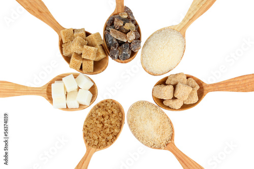 Different types of sugar in spoons isolated on white