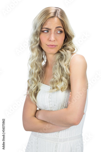 Uninterested model in white dress rising her eyebrow © WavebreakmediaMicro