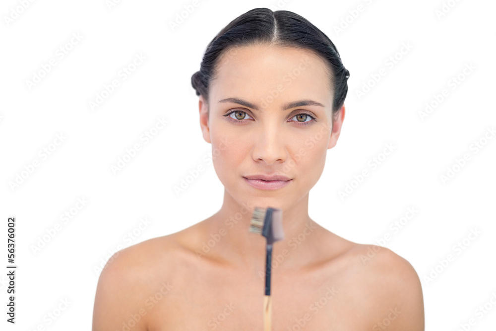 Pretty young model holding eyebrow brush