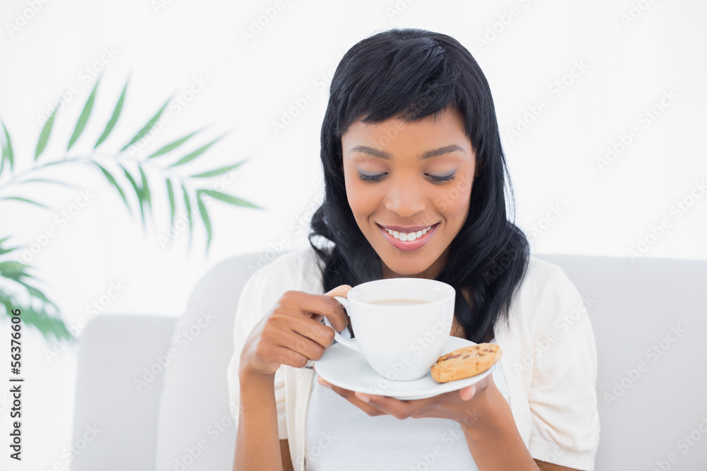 Relaxed black haired woman in white clothes drinking coffee Relaxed black haired woman in white clothes drinking coffee