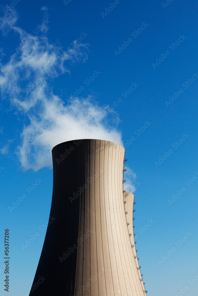 Cooling towers of nuclear power plant against a blue sky
