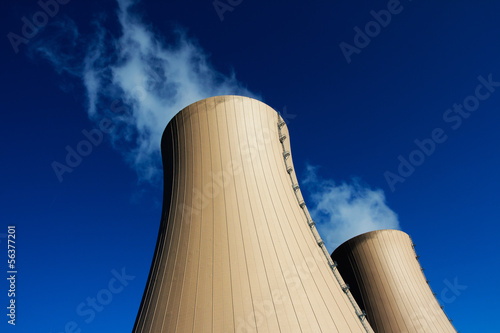 Cooling towers of nuclear power plant against  blue sky photo
