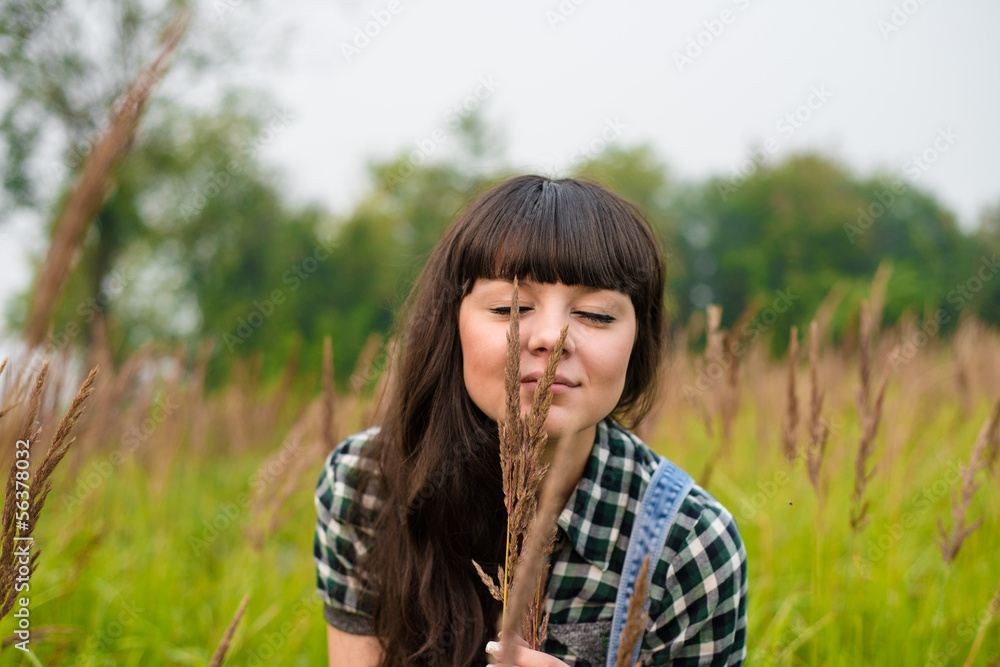Portrait of beautiful girl enjoying the nature in the field