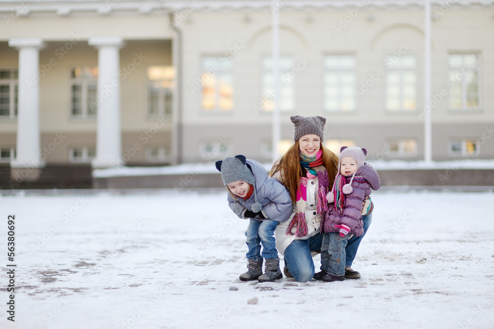 Young mother and her girls on winter day