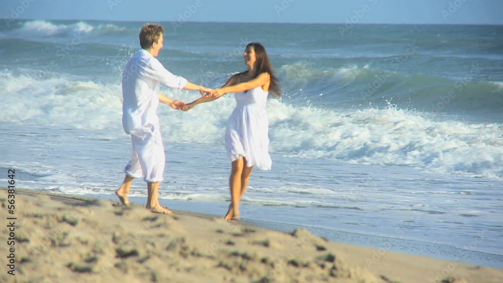 Carefree Caucasian Couple Enjoying Beach Vacation Carefree Caucasian Couple Enjoying Beach Vacation