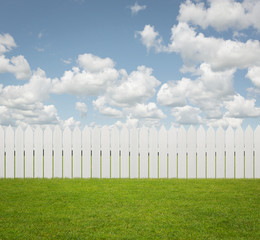 White fence on the grass with copy space