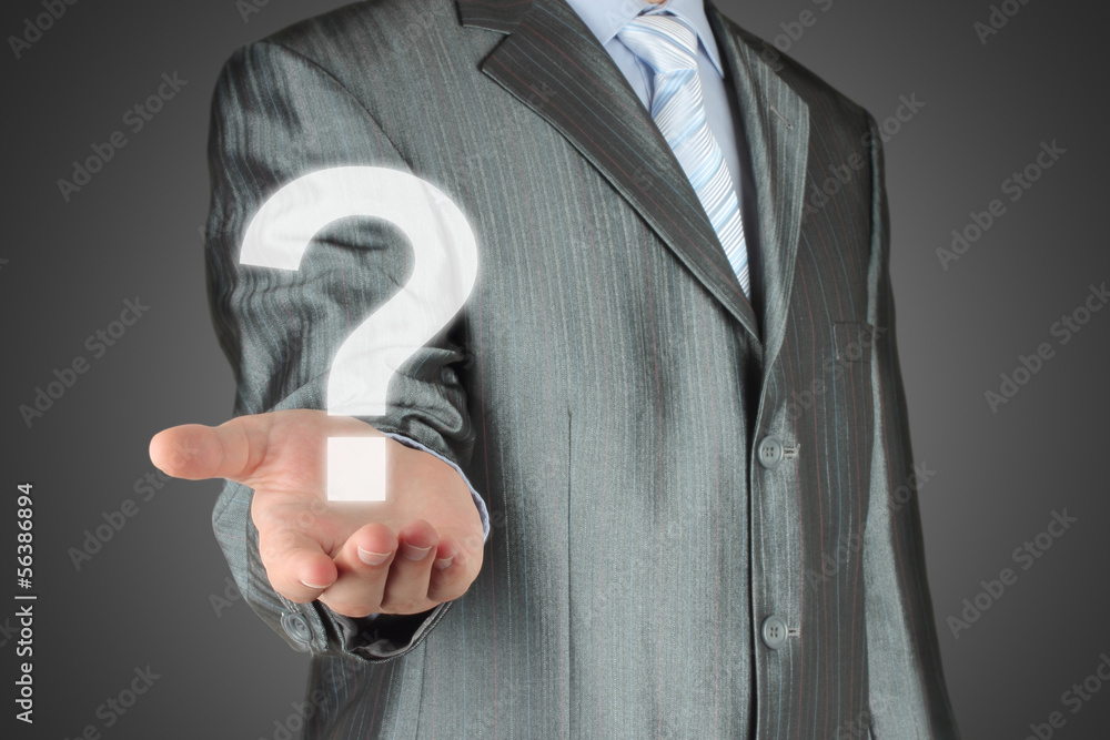 Businessman with question mark on dark background. Businessman with question mark on dark background.