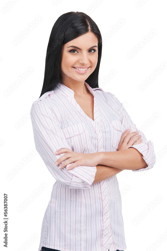Confident woman. Cheerful young woman keeping arms crossed and s Confident woman. Cheerful young woman keeping arms crossed and s