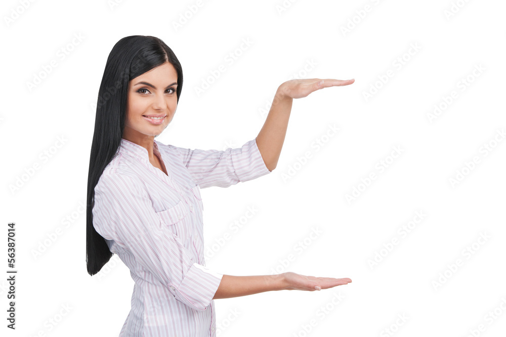 Showing the size. Cheerful young woman showing the size of somet Showing the size. Cheerful young woman showing the size of somet