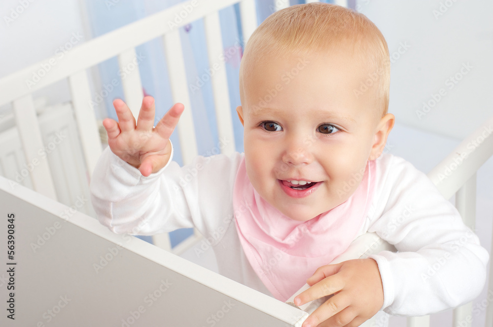 Portrait of a cheerful baby waving hello Portrait of a cheerful baby waving hello