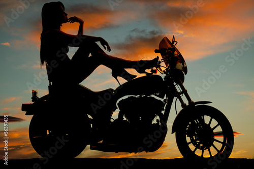 Fototapeta Naklejka Na Ścianę i Meble -  silhouette woman motorcycle heels up hand chin