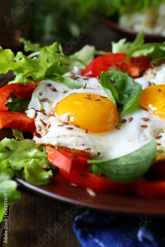 fried eggs with fresh peppers and herbs