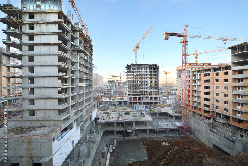 Multi-storey buildings under construction and cranes