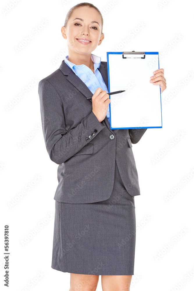 Friendly businesswoman pointing to a clipboard Friendly businesswoman pointing to a clipboard