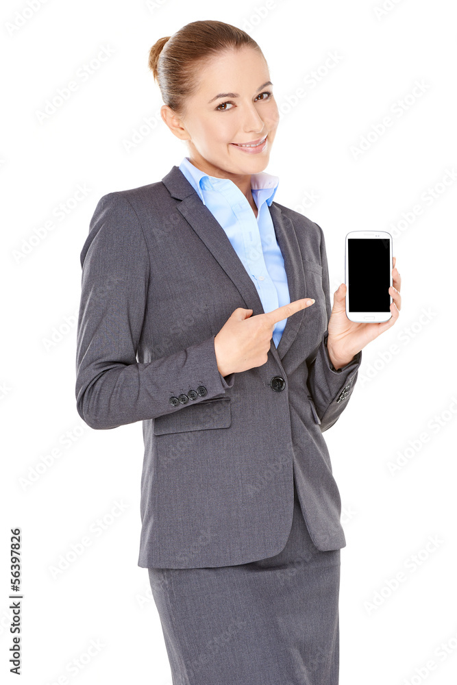 Smiling businesswoman pointing to her mobile Smiling businesswoman pointing to her mobile