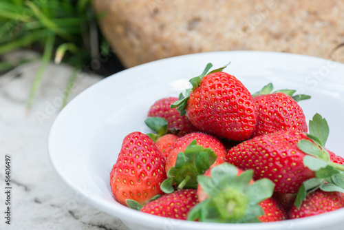Strawberries in a bowl in the garden