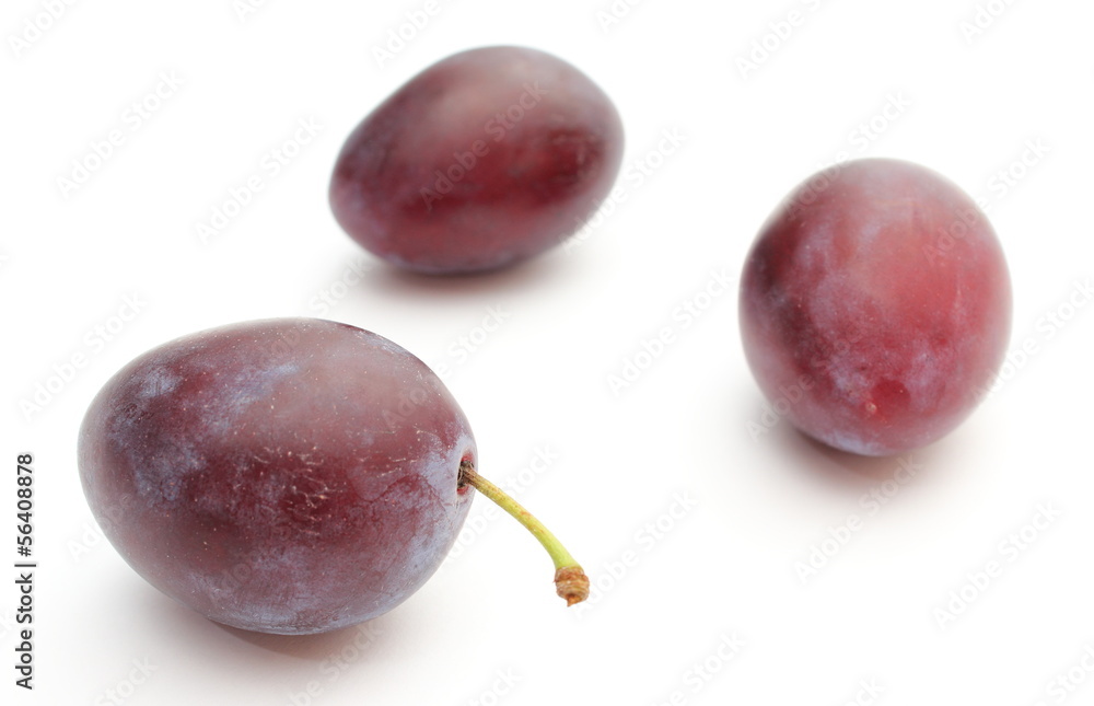 Fototapeta premium Fresh and natural plums on a white background